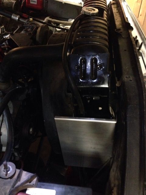 1978 Ford Bronco - Close-up view of the radiator and coolant hoses within the engine compartment.