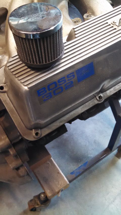 1988 Ford Bronco - Close-up of a Ford Boss 302 valve cover with a chrome air filter attached.