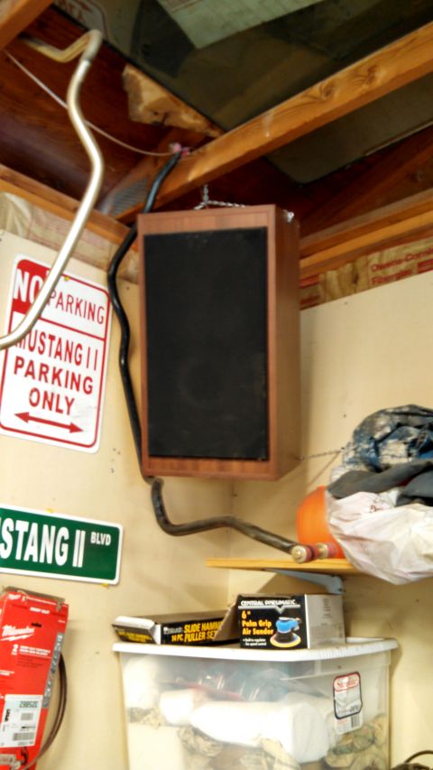 1988 Ford Bronco - Speaker mounted from ceiling near Mustang II signs and storage bins.