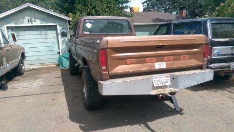 1976 Ford F-250 - This brown 1976 Ford F-250 pickup truck is viewed from the rear, a custom bumper and trailer hitch.