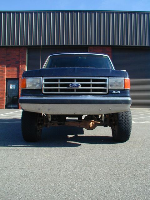 1988 Ford Bronco - Front view of a lifted 1987 Ford Bronco with 4x4 badging.