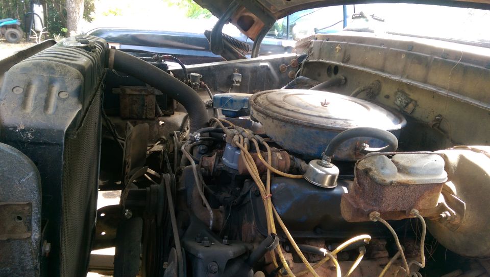 Engine bay with radiator, air cleaner, and brake fluid reservoir visible