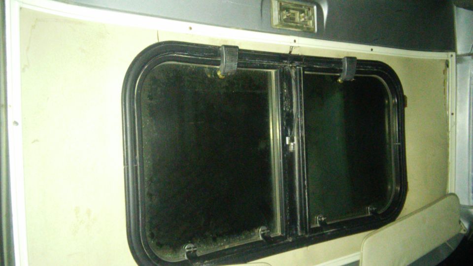 Interior window with black trim and latch