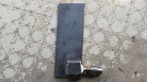 Metal bracket with 'Frame' and 'Top' markings, attached to a fitting