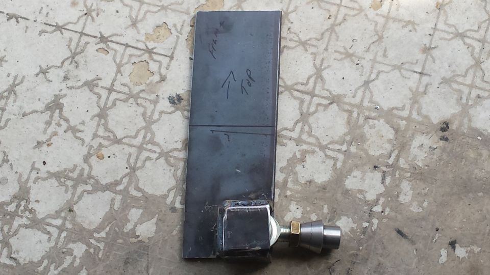 Metal bracket with 'Frame' and 'Top' markings, attached to a fitting