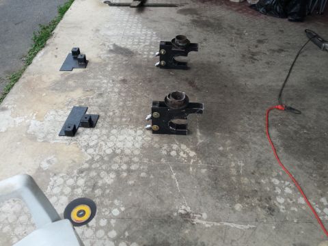Black suspension parts and metal brackets on concrete floor