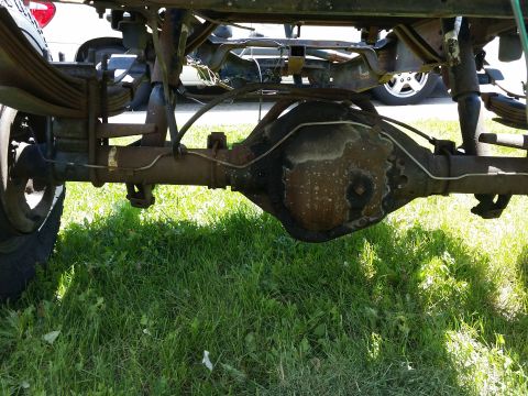 1988 Ford Bronco - Close-up view of a vehicle's rear axle and suspension system, including leaf springs.