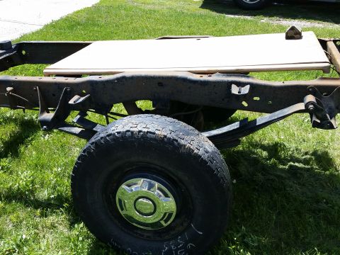 1988 Ford Bronco - The chassis of a truck is shown from the side, with a focus on the rear suspension and wheel.