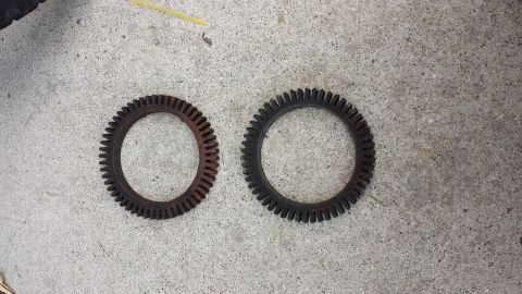 1995 Ford Bronco - Two toothed rings, possibly for a vehicle, lie on a concrete surface.