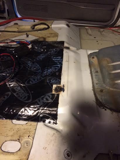 1995 Ford Bronco - The interior floor of a vehicle is shown with sound deadening material and exposed wiring.