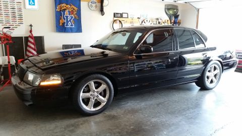 2003 Mercury Marauder - A black 2003 Mercury Marauder is parked in a garage with a blue University of Kentucky banner on the wall.