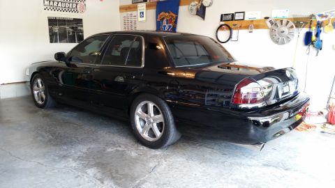 2003 Mercury Marauder - A black 2003 Mercury Marauder is parked in a garage, with various items on the wall behind it.