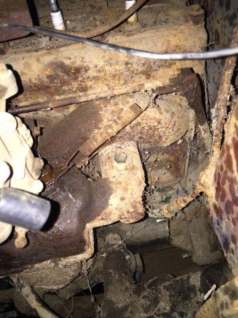 1946 Jeep Willys - This is a close-up, low-angle shot of heavily rusted engine components, likely from an older vehicle. Visible parts include spark plug wire…