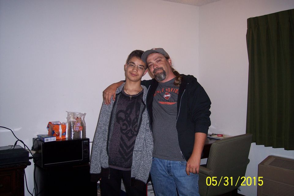 Two males posing for a photo indoors.