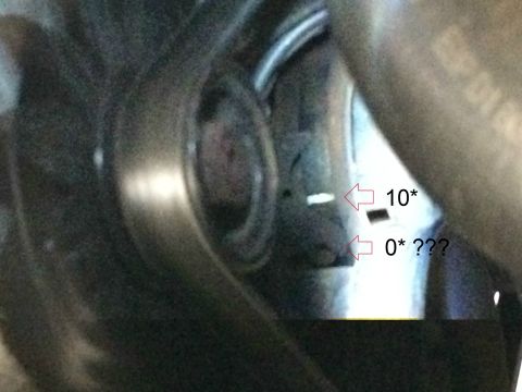 1989 Ford Bronco - A close-up view of a vehicle's mechanical components, possibly an engine bay, with two measurement markers indicated by arrows. One marker…