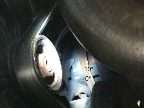 1989 Ford Bronco - A close-up view shows a pulley system with markings indicating '10*' and '0*'. The surrounding area is dark and appears to be an engine bay.