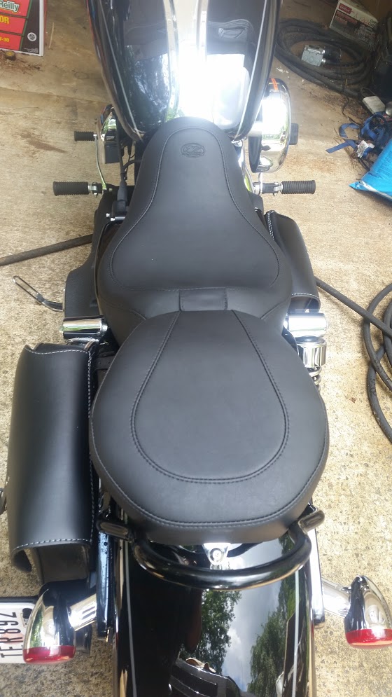 Black motorcycle with two-up seat and saddlebag, overhead view.