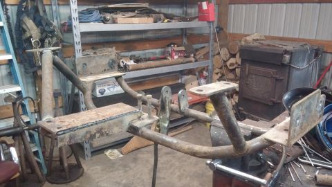 1995 Ford Bronco - A custom-fabricated metal frame, likely a trailer hitch or suspension component, is shown in a workshop setting. The frame is made of welde…