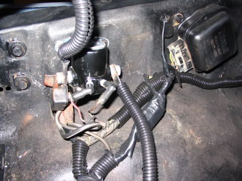 1979 Ford Bronco - A close-up view of the engine bay of a 1979 Ford Bronco, showing the starter solenoid and voltage regulator with associated wiring harnesse…