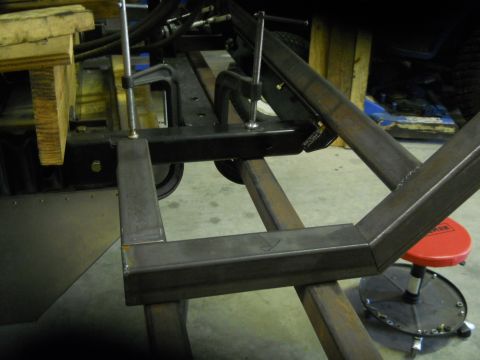 1992 Ford Bronco - A close-up view of metal frame components being clamped together, likely part of a vehicle chassis or custom build. The scene appears to be…