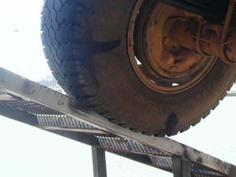 1988 Ford Bronco - Tire and suspension components are visible on a ramp with painted measurements.