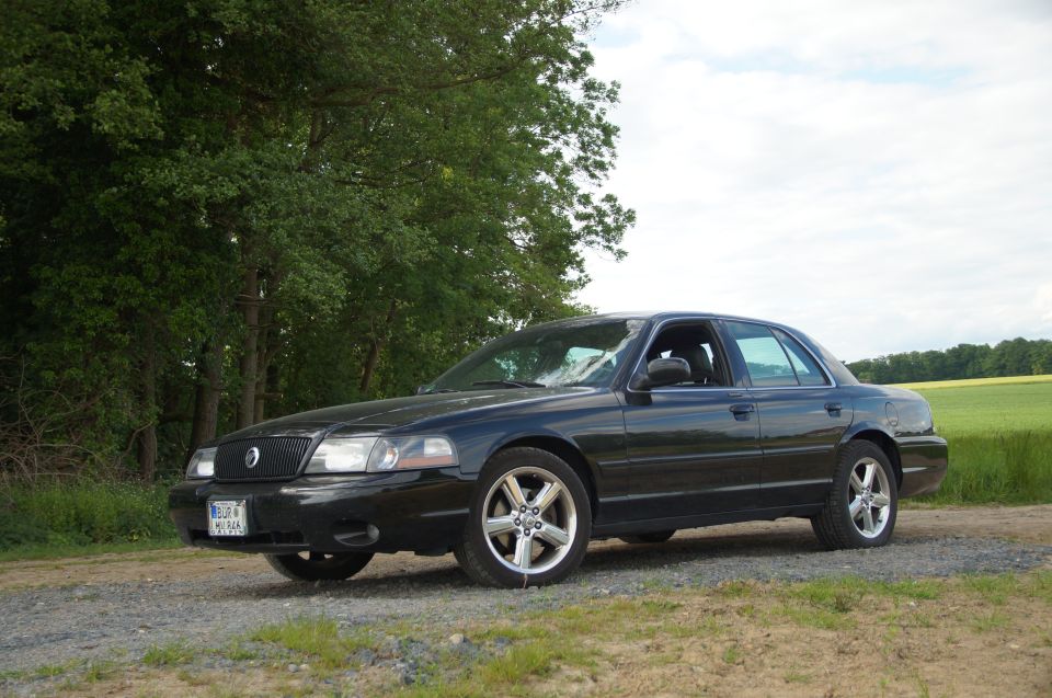 Black 2003 Mercury Marauder parked on a gravel road.