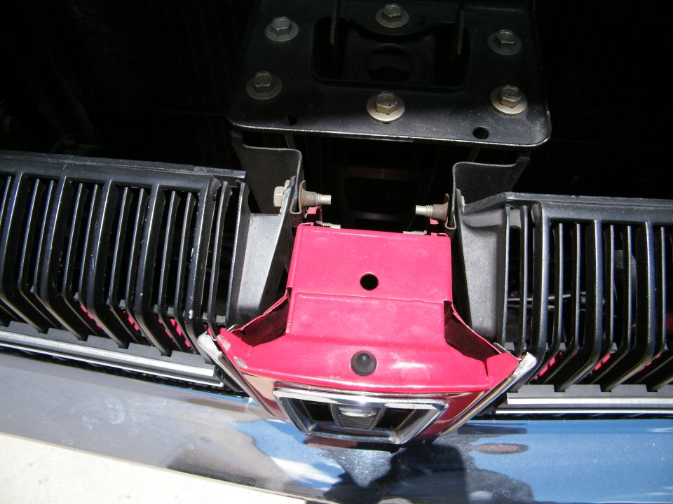 1968 Mercury Cougar front grille and red hood latch mechanism.