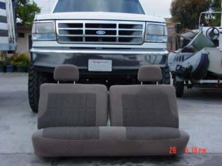 1992 Ford Bronco - Front view of a 1992 Ford Bronco, showing the grille and headlights, with the interior bench seat positioned in front.