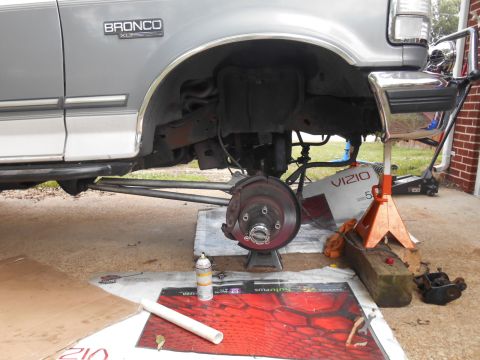 1994 Ford Bronco - The front passenger side of a lifted 1994 Ford Bronco is shown with the wheel removed and the vehicle supported by jack stands. The suspens…
