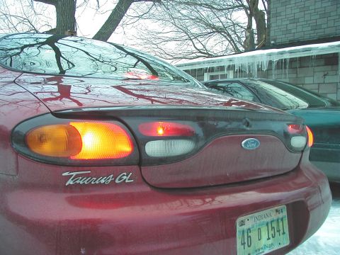 1997 Ford Taurus - Rear view of a red 1997 Ford Taurus GL showing its taillights and license plate.