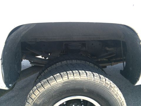 1997 Dodge 3500 - Close-up view of the rear suspension system of a heavy-duty truck, highlighting the leaf springs and auxiliary air springs.
