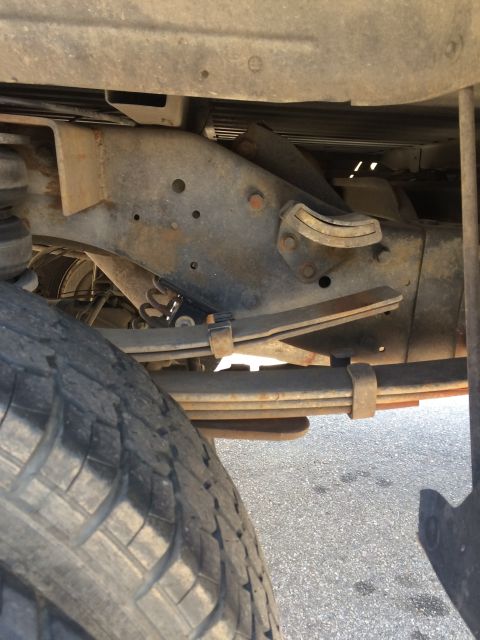 1997 Dodge 3500 - Close-up view of the undercarriage of a truck, focusing on the suspension system.