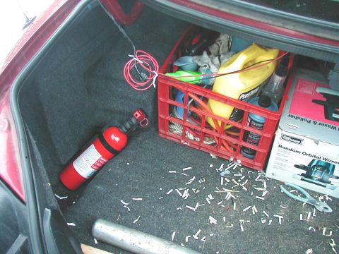 1997 Ford Taurus - Fire extinguisher and supplies stored in the trunk of a car.