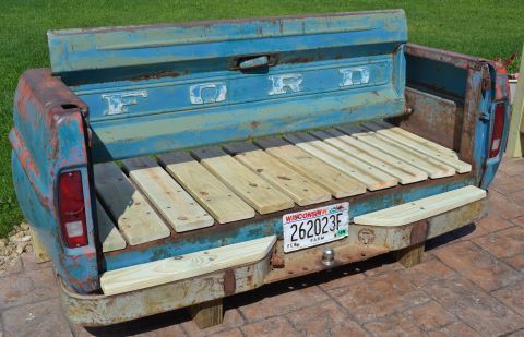 1994 Ford Bronco - This repurposed Ford truck tailgate has been transformed into a unique bench, complete with a wooden seat and a Wisconsin license plate.