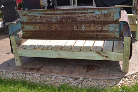 1994 Ford Bronco - A bench constructed from a weathered truck tailgate and new wooden planks sits outdoors on a patio.