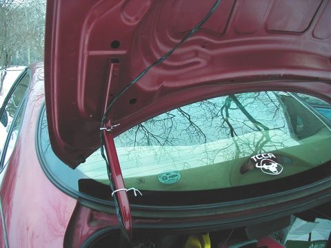1997 Ford Taurus - The interior of a car's trunk is visible with the lid open, revealing the rear window and some stickers.