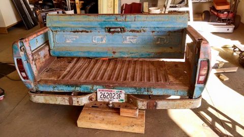 1994 Ford Bronco - This is the rear section of a blue Ford pickup truck bed, showing significant rust and wear.