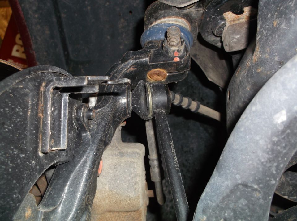 close-up of car's front suspension parts, including ball joint and control arm
