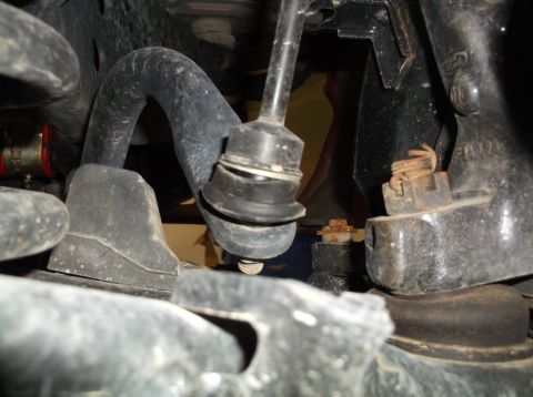 1999 Mercury Grand Marquis - Close-up view of rusted suspension components, including a sway bar link and mounting hardware.