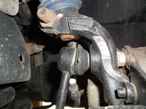 1999 Mercury Grand Marquis - Damaged suspension stabilizer link showing a cracked rubber bushing, indicating a need for front-end repair.