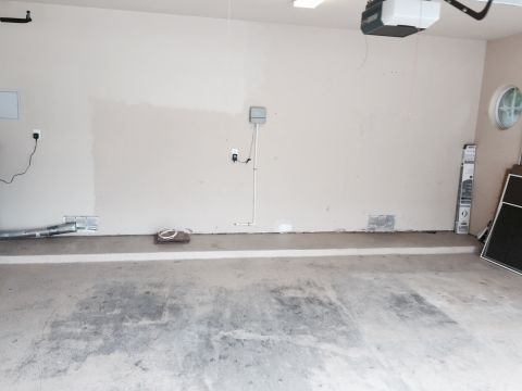2015 Ford Deluxe - This image shows an empty garage interior with no vehicles present.