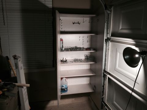 2015 Ford Deluxe - Organized garage storage cabinet with shelves filled with hardware and supplies.