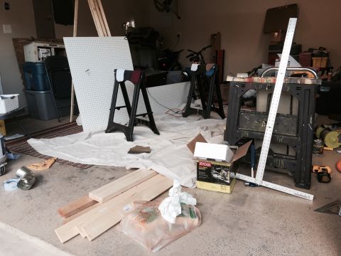 2015 Ford Deluxe - A cluttered garage interior shows construction materials and tools, not a 2015 Ford Deluxe.