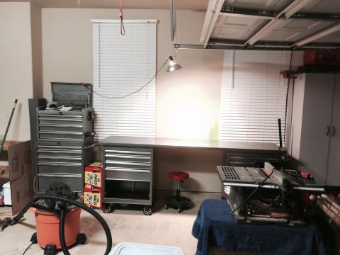 2015 Ford Deluxe - A workshop scene tool storage, a workbench, and a table saw, with a shop vac visible.