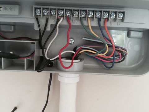 2015 Ford Deluxe - Close-up view of the wiring terminals inside a gray irrigation controller box.