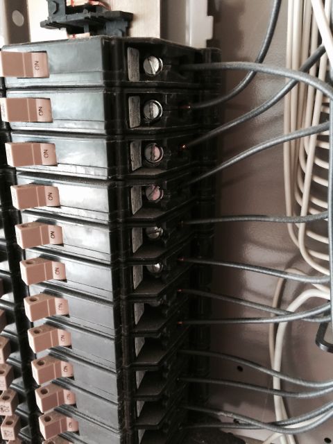 2015 Ford Deluxe - Close-up view of an electrical breaker panel, showing stacked circuit breakers and connected wiring.