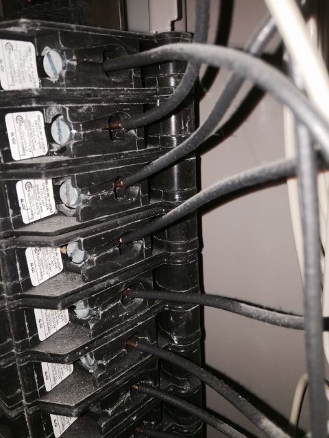 2015 Ford Deluxe - This image shows a close-up view of an electrical breaker panel with several wires connected to the breakers.