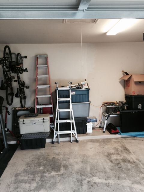 2015 Ford Deluxe - Interior view of a garage with various items stored, including bicycles and ladders.