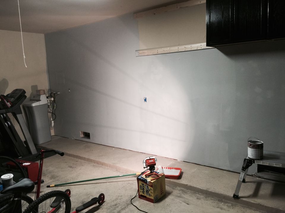 Garage interior with paint can, roller, and treadmill
