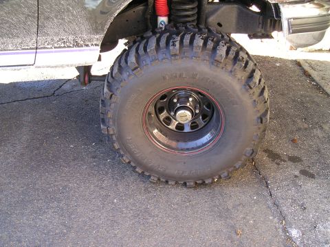 1994 Ford F-150 - Close-up of a large truck tire and suspension components.